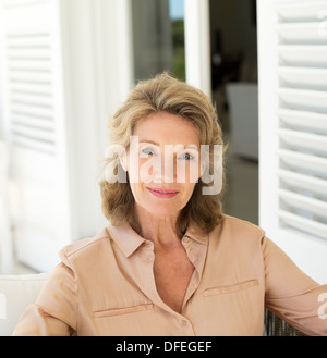 Portrait of smiling senior woman on patio Stock Photo