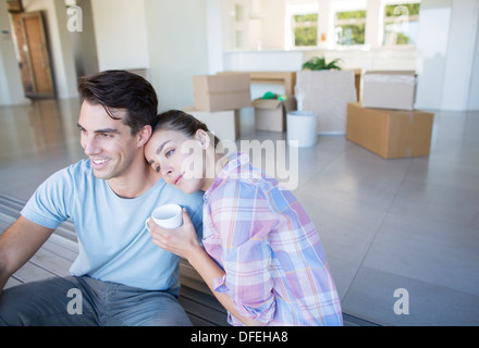 Couple drinking coffee in new house Stock Photo