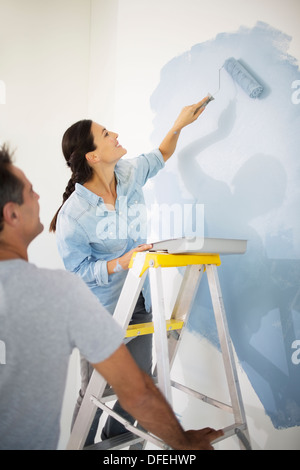 Couple painting wall blue Stock Photo