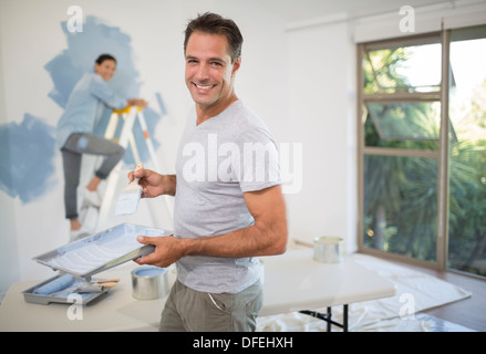 Couple painting wall blue Stock Photo