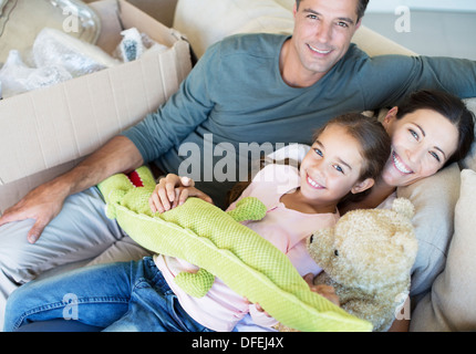 Portrait of smiling family with stuffed animals on sofa Stock Photo