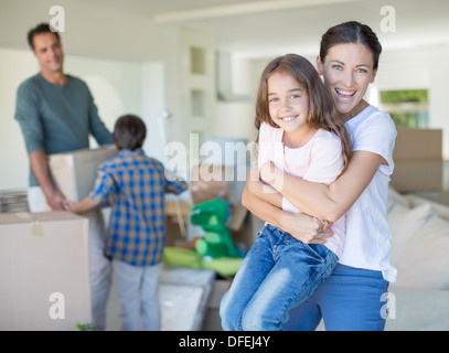 Mother and daughter hugging in new house Stock Photo