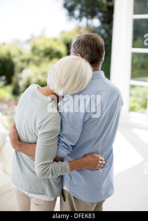 Senior couple hugging on patio Stock Photo