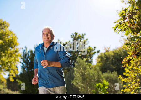 Senior man running in park Stock Photo