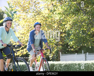 Senior couple riding bicycles in park Stock Photo