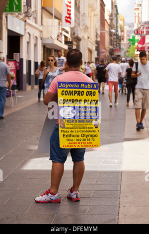 Man with sandwich board advertising pawn shop with offers to buy gold, silver and luxury watches in Santa Cruz, Stock Photo