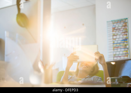 Businesswoman using digital tablet in office Stock Photo