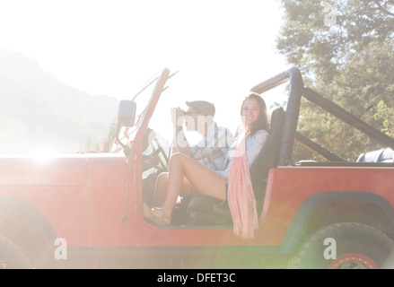 Couple sitting in sport utility vehicle Stock Photo