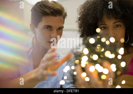 Business people examining ball of string lights Stock Photo