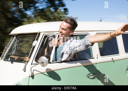 Man leaning head out camper van window Stock Photo