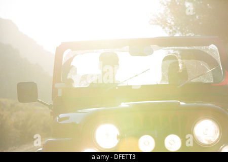 Couple driving sport utility vehicle Stock Photo