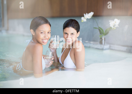 Portrait of smiling women in swimming pool at spa Stock Photo