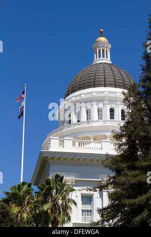 California state capitol dome and flags against a blue sky. Stock Photo