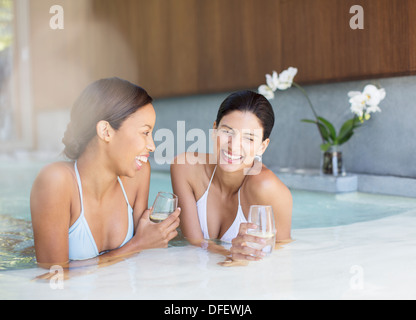 Women laughing in hot tub at spa Stock Photo