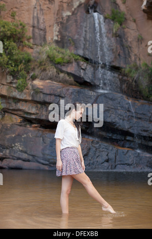 Woman wading in pool Stock Photo