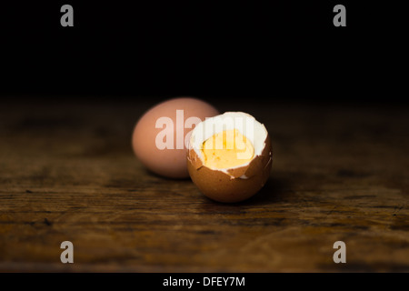 Two hardboiled eggs on wood surface Stock Photo
