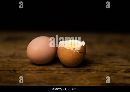 Two hardboiled eggs on wood surface Stock Photo