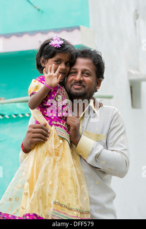 Indian Father and Daughter waving and smiling. Andhra Pradesh, India Stock Photo