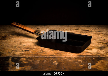 Square Japanese tamago frying pan on wooden surface Stock Photo