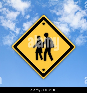 School warning sign on yellow with a blue sky background Stock Photo