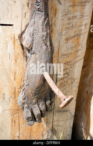 foot of a wooden Jesus Christ on the cross closeup Stock Photo