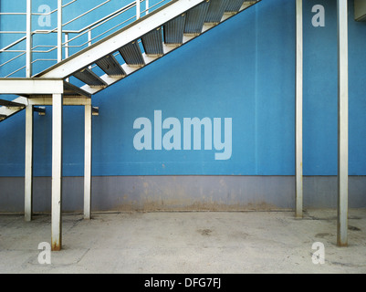 Wall background under metal staircase. Stock Photo