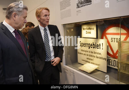 Berlin, Germany. 04th Oct, 2013. Mayor of Berlin Klaus Wowereit (L) walks through the new permanent exhibition at the former Stasi prison with Director Hubertus Knabe (R) of the Stasi Memorial Berlin-Hohenschoenhausen in Berlin, Germany, 04 October 2013. There are around 500 exhibition pieces and more than 300 historic photos on display in the 700 square meter exhibition. The experiences of prisoner is at the center of the exhibition. Photo: BERND VON JUETRCZENKA/dpa/Alamy Live News Stock Photo