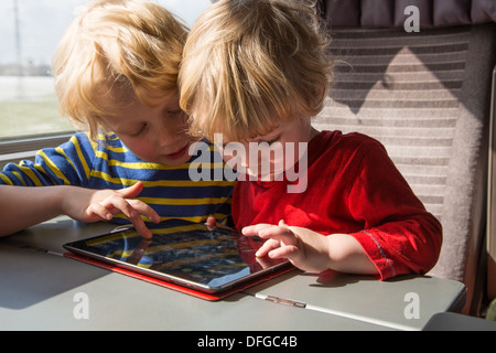 Two Brothers playing on an iPad Stock Photo