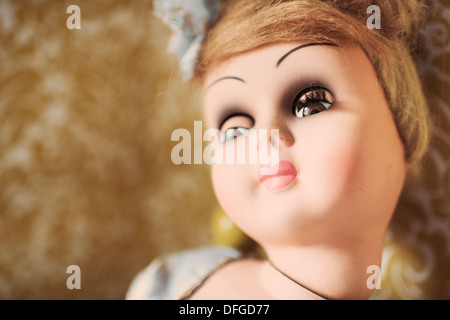 Close up of old fashioned doll looking away with bored expression Stock Photo