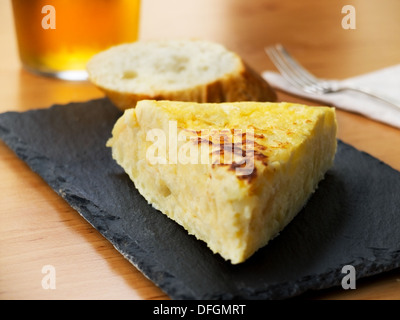 Typical spanish pincho de tortilla de patatas in slate plate Stock Photo