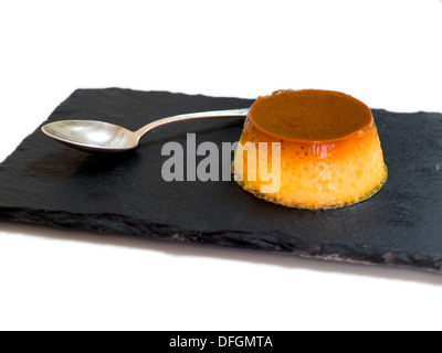 Caramel custard in a slate plate. Stock Photo