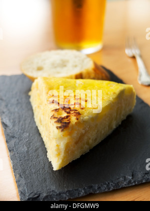 Typical spanish pincho de tortilla de patatas in slate plate Stock Photo