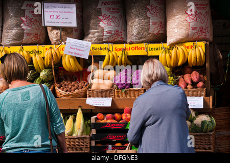 Women Browsing Outside A greengrocers Fruit and Veg Shop Display UK Stock Photo