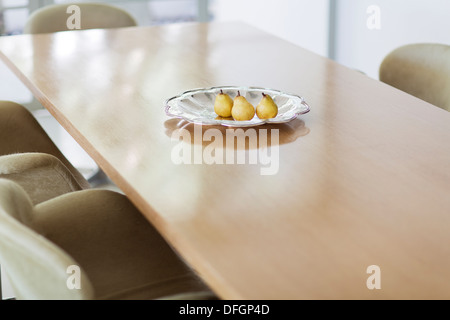 Pears in glass dish on dining table Stock Photo