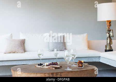 Wine and cheese on coffee table in modern living room Stock Photo