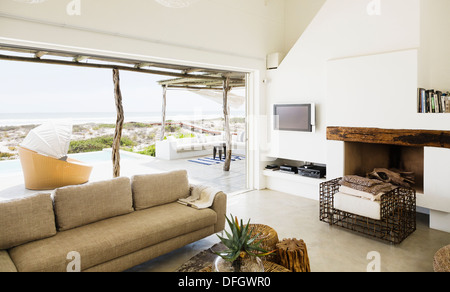 Modern living room overlooking ocean Stock Photo