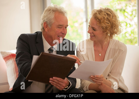 Financial advisor explaining paperwork to woman Stock Photo