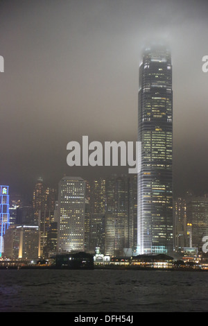 Two International Finance Centre (2IFC) Hong Kong China seen at night from Star Ferry in heavy mist Stock Photo