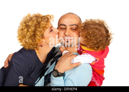 Mom and daughter kissing dad isolated on white background Stock Photo