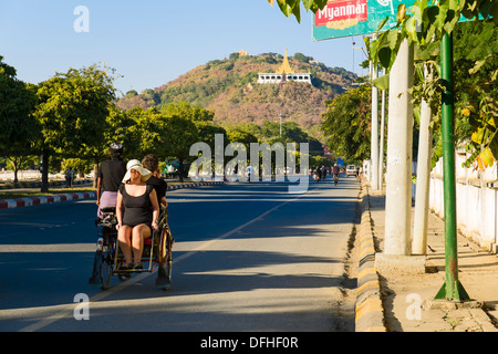 Tourists on trishaw, road to Mandalay Hill, Mandalay, Myanmar, Asia Stock Photo