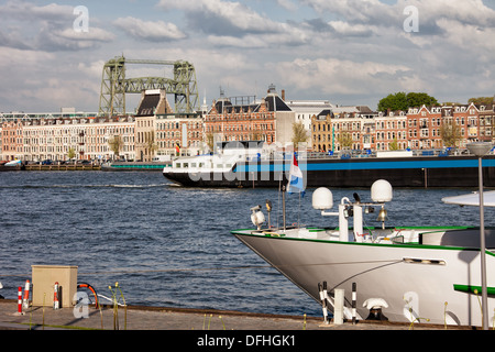 City of Rotterdam urban scenery, riverside housing, barges and ships on Nieuwe Maas river in South Holland, Netherlands. Stock Photo