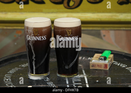 Image of two pint glasses of Guinness outside a pub on Arthur's Day 2013 Stock Photo