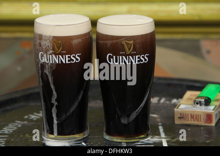 Image of two pint glasses of Guinness outside a Dublin pub on Arthur's Day 2013 Stock Photo
