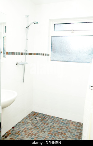 A specially adapted wet room shower / bathroom with non slip tiles used for the flooring suitable for disabled people Stock Photo