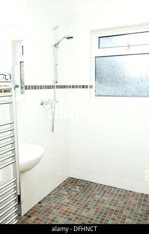 Non slip tiles used for the flooring in a wet room (shower bathroom) suitable for disabled use 