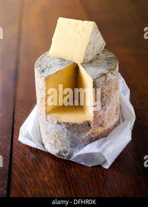 Whole cheddar cheese truckle of mature farmhouse cheddar cheese Stock Photo