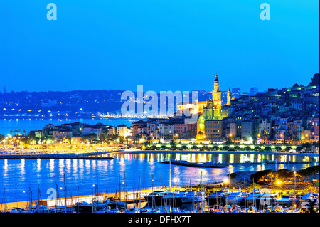 Europe, France, Alpes-Maritimes, Menton. Basilica Saint Michel and the marina at night. Stock Photo