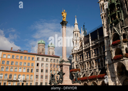 Virgin Mary atop the Mariensaeule, neues Rathaus and the church towers of the Frauenkirche in Munich, Bavaria, Germany Stock Photo