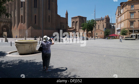 Female tourist photographing Albi Cathedral, Place Sainte Cécile, Albi, Tarn, France Stock Photo