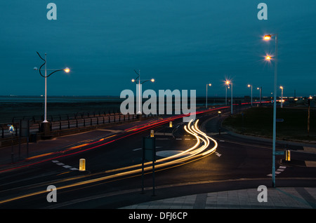 cars driving on the roundabout at night in Southport UK Stock Photo